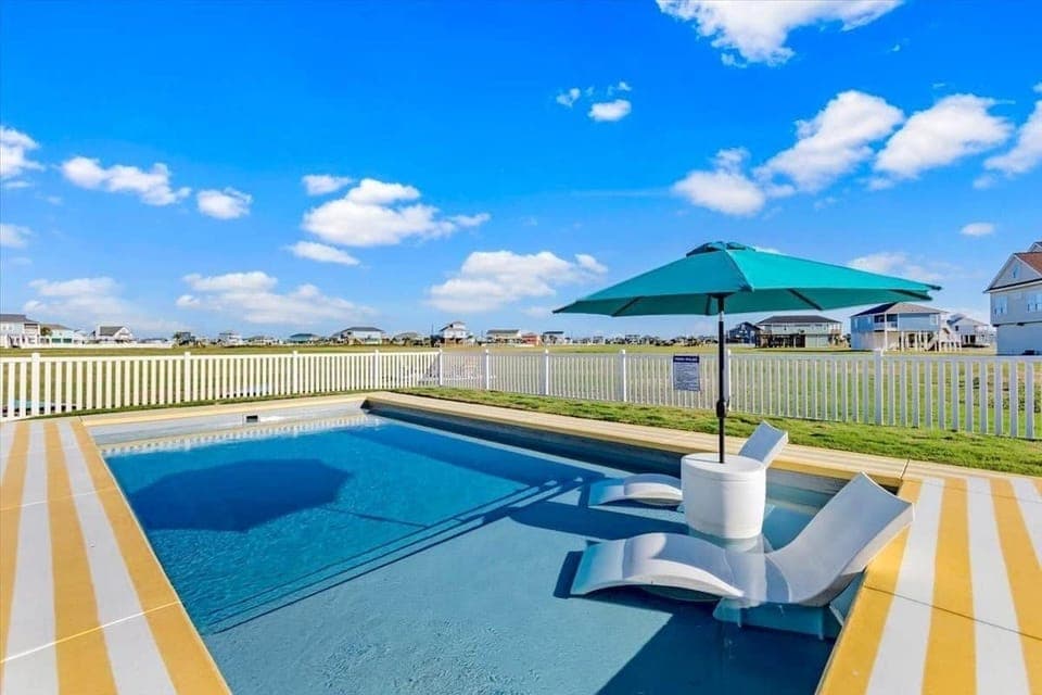 Relax with a cold drink in the pool- your umbrella table doubles as an ice chest