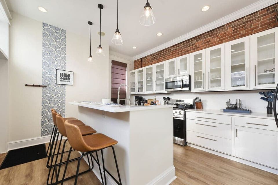 Dining and kitchen flow for easy entertaining, featuring a large island and bar seating.