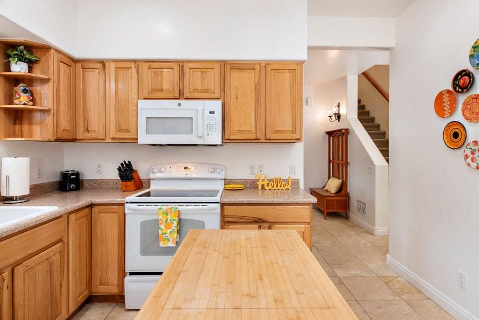 Kitchen looking to dining area and stairwell