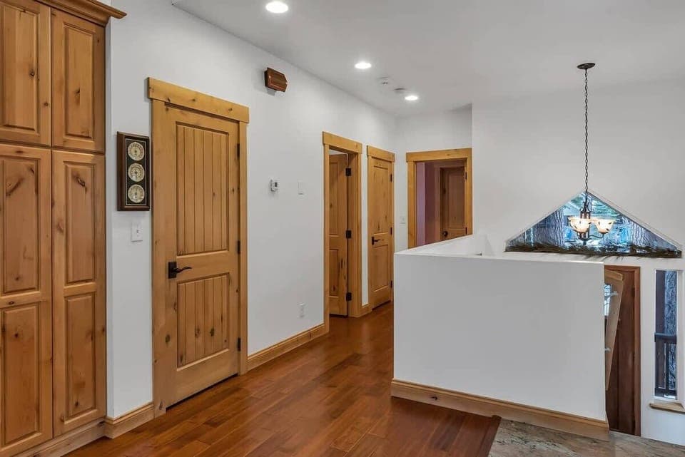 The view down the upstairs hallway where you will find a powder room and the master bedroom.