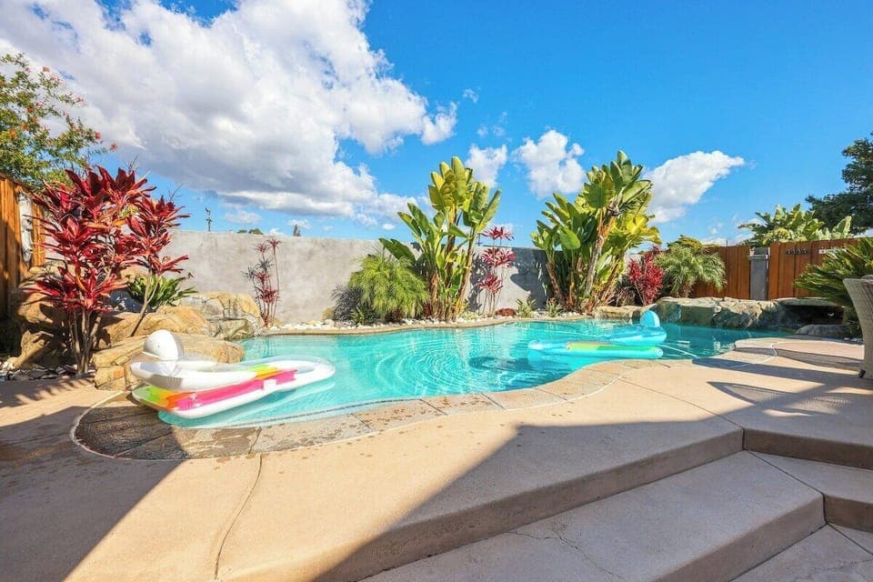 Sparkling Pool Oasis – Dive into luxury with a shimmering pool surrounded by lush tropical landscaping. Relax under the sun, float on a raft, or unwind in this private backyard paradise.