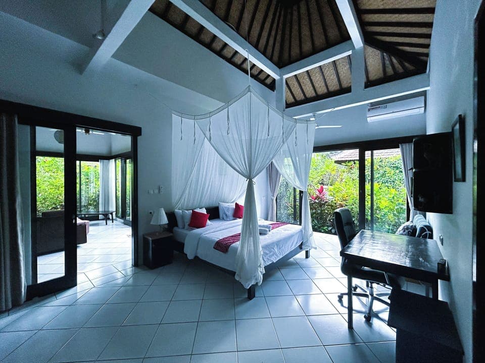 Spacious bedroom, glass window with garden view, work desk and wardrobe