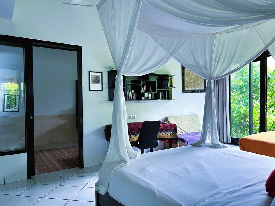 Spacious bedroom, glass window with garden view, work desk and wardrobe