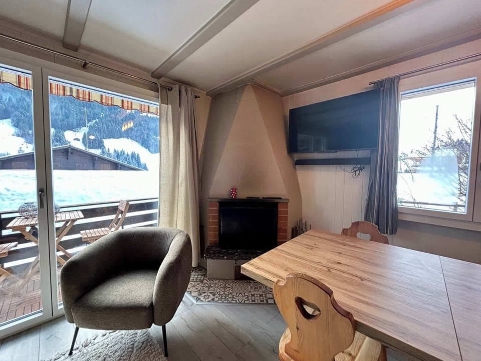 living room table next to warm fire place 