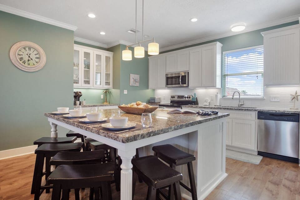 One TipSea Time Kitchen: Entertain guests in style in this luxurious kitchen, featuring an expansive island with bar seating, perfect for serving hors d'oeuvres and cocktails.