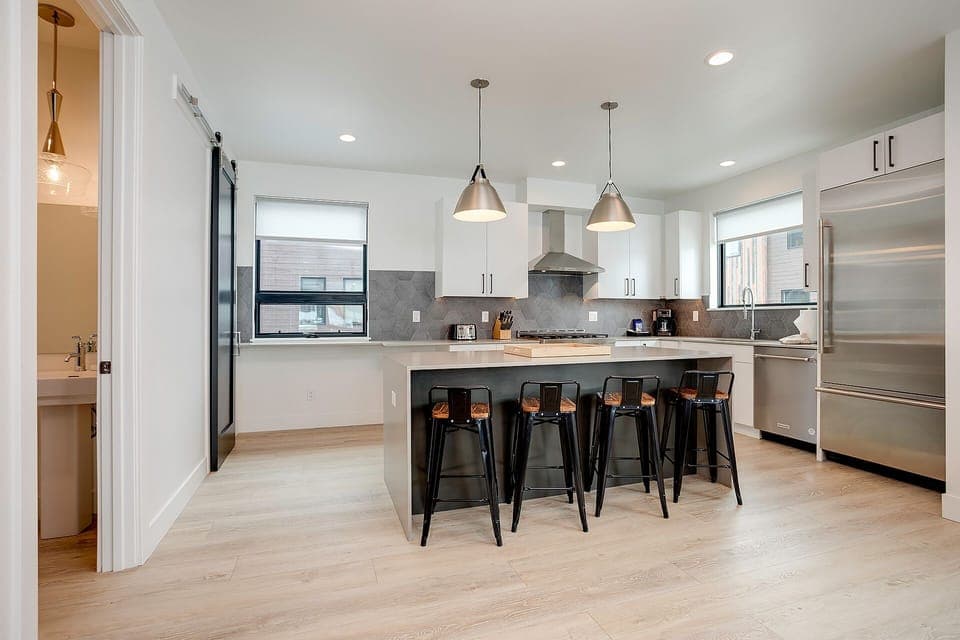 Your sleek kitchen awaits with premium appliances, spacious island seating, and modern finishes for memorable meals together.
