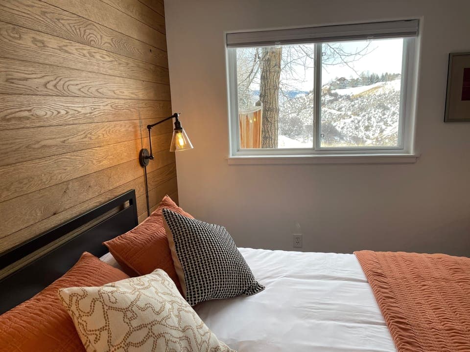 Valley views from your queen bed. The  shade has blackout and privacy options.