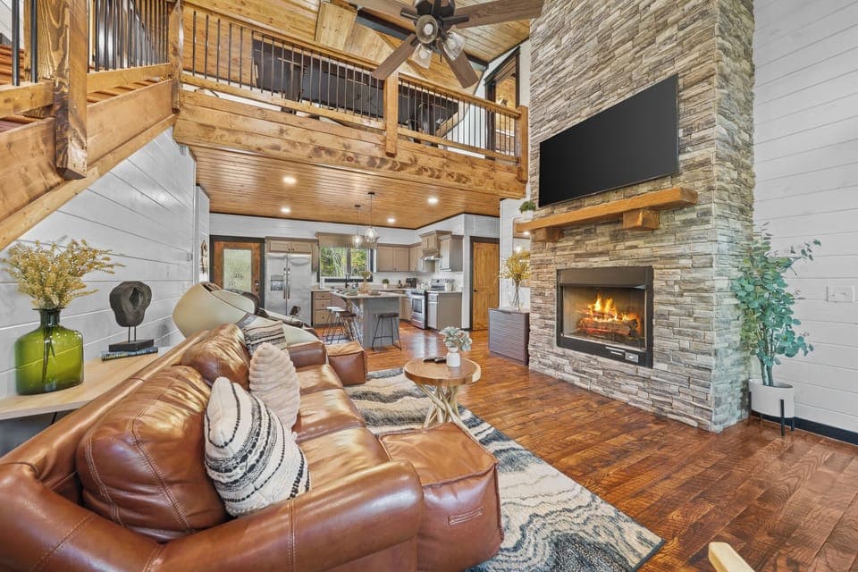 Open living room seamlessly flows into the adjacent kitchen and dining area, creating a spacious living space
