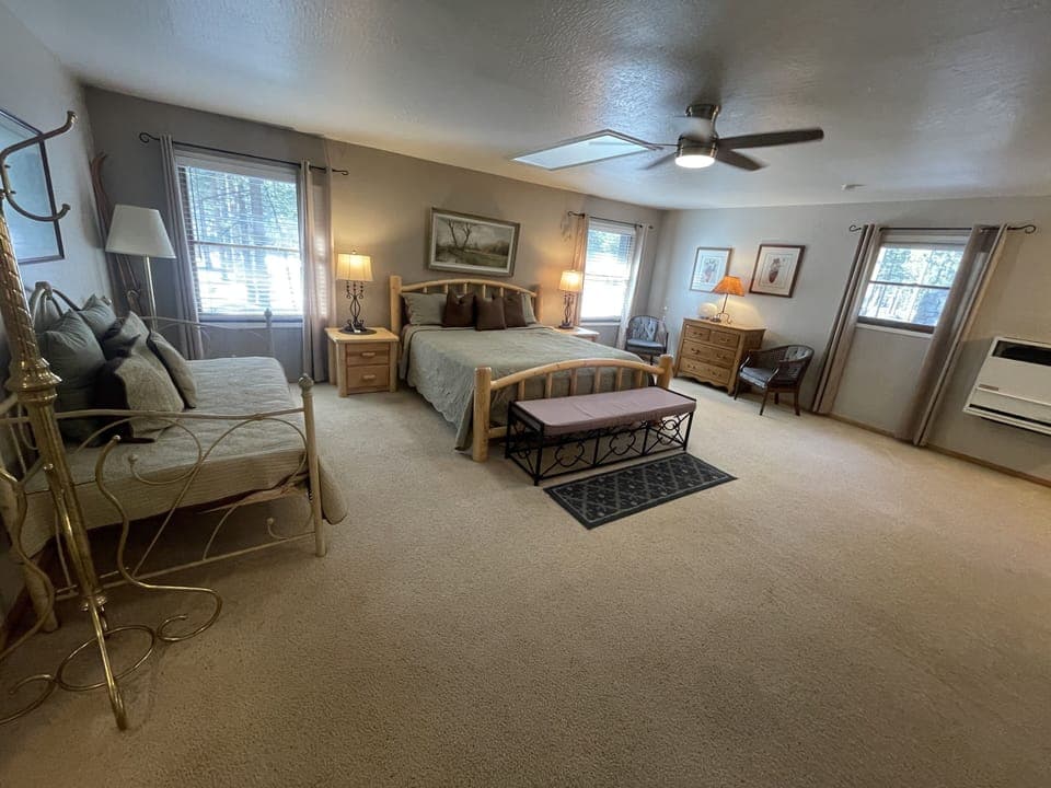 Upstairs primary bedroom with daybed and en suite full bathroom