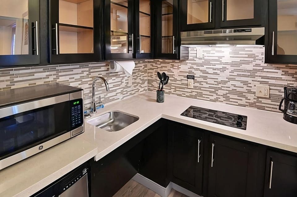 Brew coffee and prep snacks on sleek, modern counters.