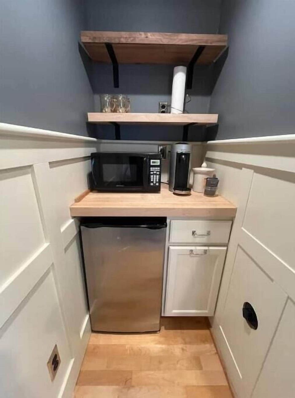 Kitchenette complete with Nespresso coffee maker, microwave, and mini fridge. 
