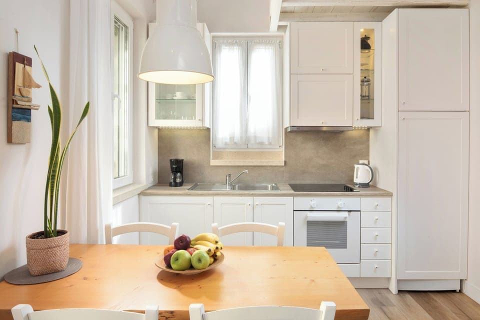 "Prepare delicious meals in our fully equipped kitchen, complete with a dining table for four."