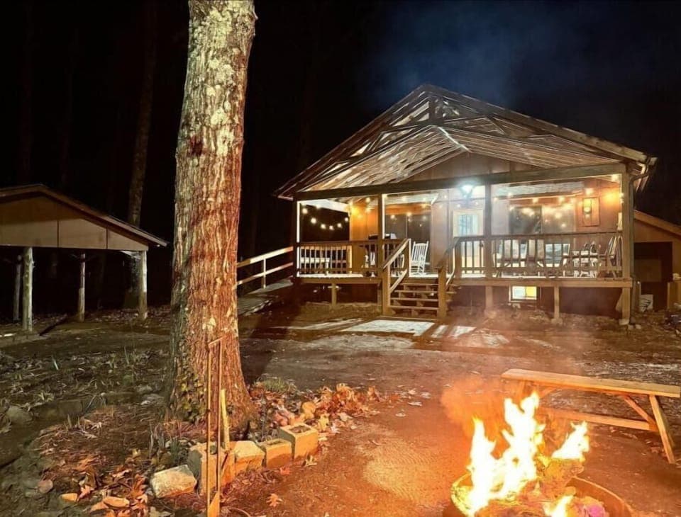 Fire pit with seating area in front of cabin.