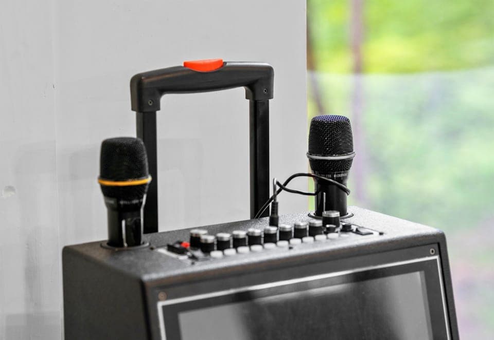 Microphone check! Channel your inner pop star and add some music magic to your vacation with our professional karaoke setup.