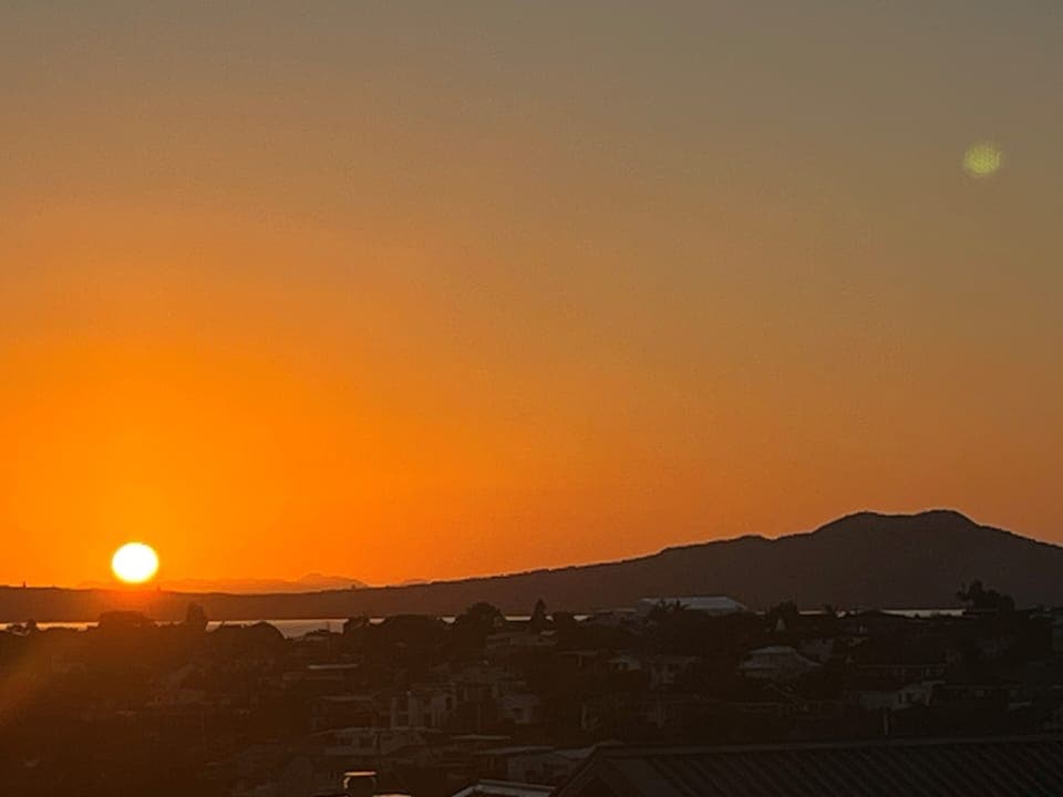 Sunrise over Rangitoto Island (volcano) from main deck & kitchen/dining/lounge 