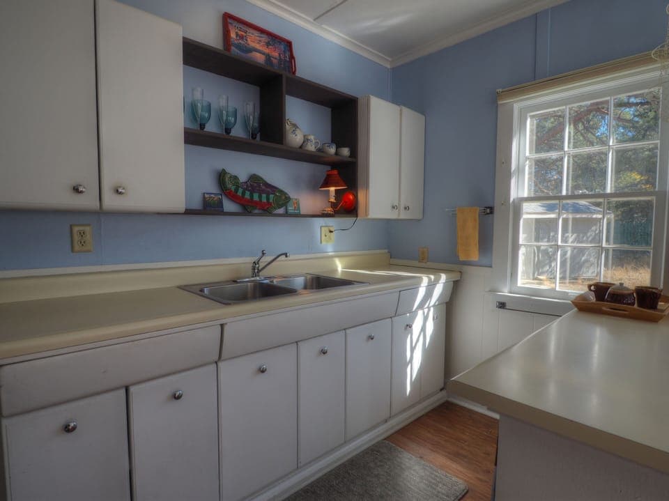Plenty of drawer and counter space in the sunlit kitchen area.