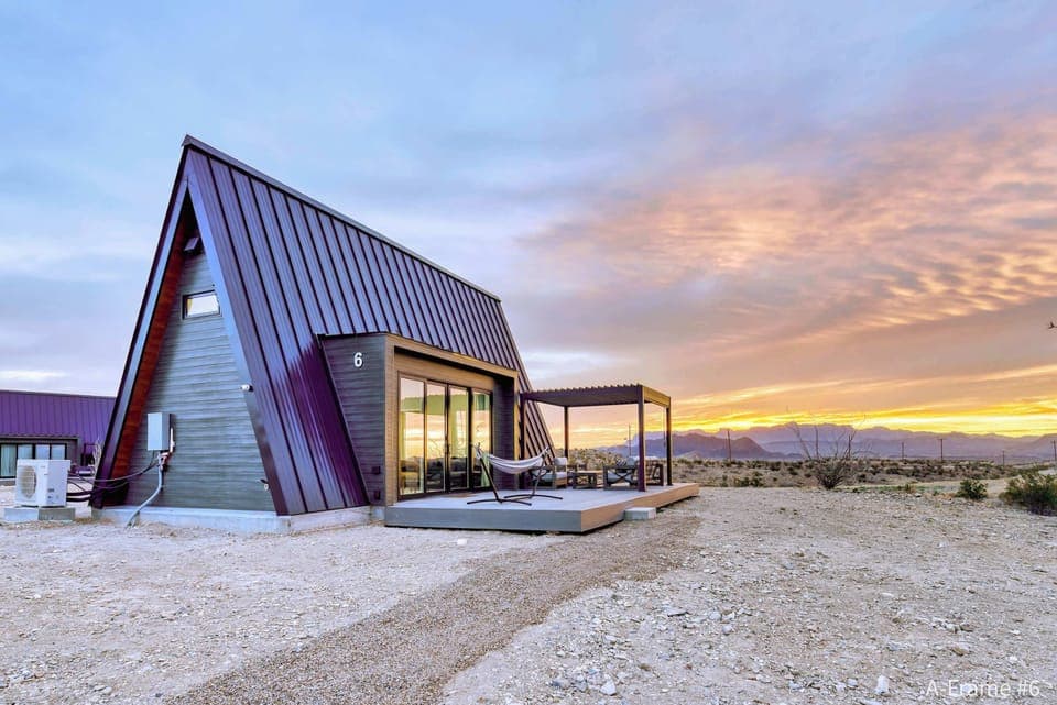 Exterior view of A-Frame #6  with a gorgeous sunrise behind the Chisos Mountains