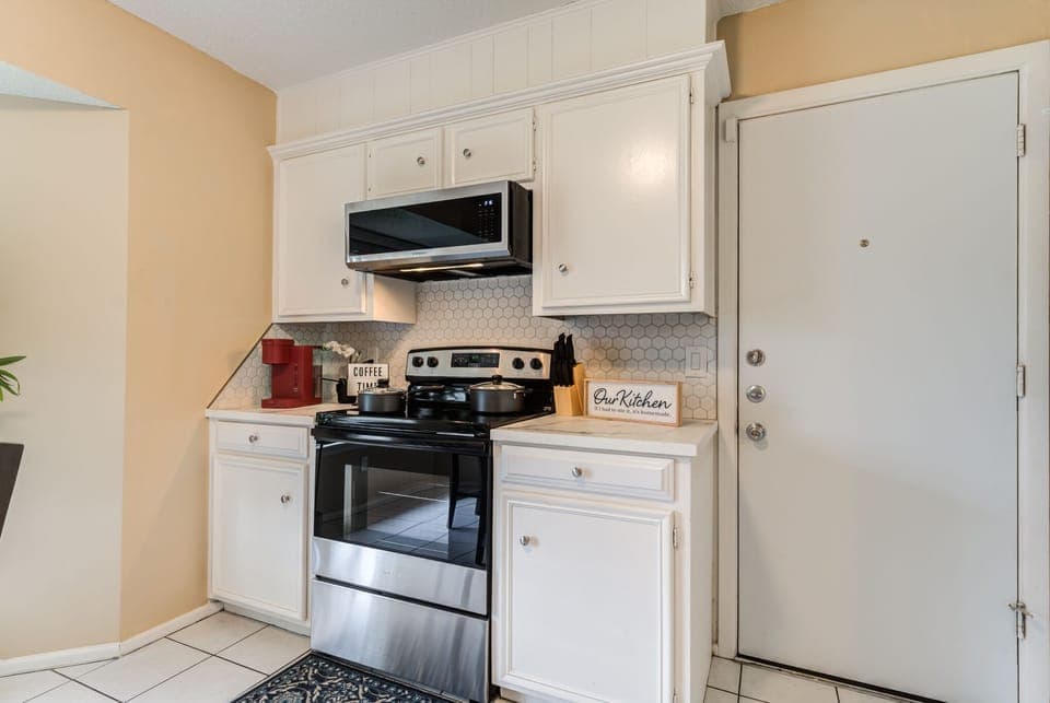 Kitchen fitted with cookware and utensils