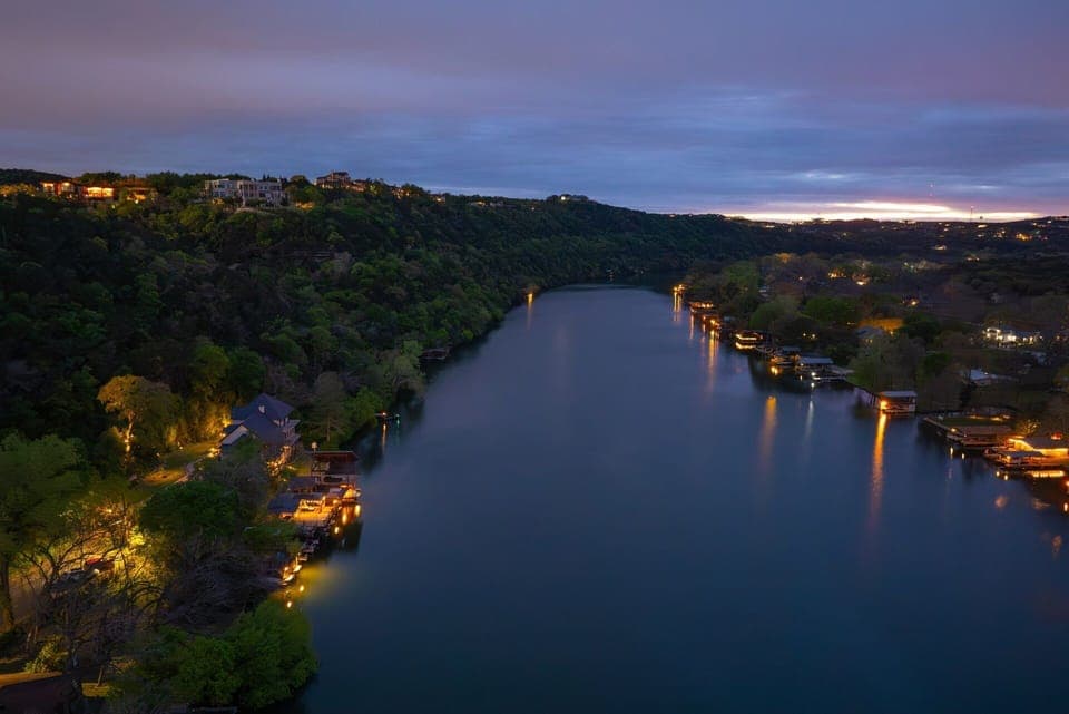 Aerial View | Boat dock illuminated on left side of the lake