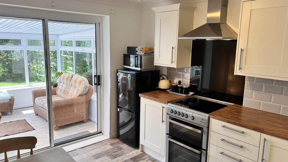 Well equipped kitchen with single oven, hob, fridge freezer and plenty of cutlery, crockery, utensils, pots, pans etc. Toaster, Microwave, kettle, bluetooth radio.