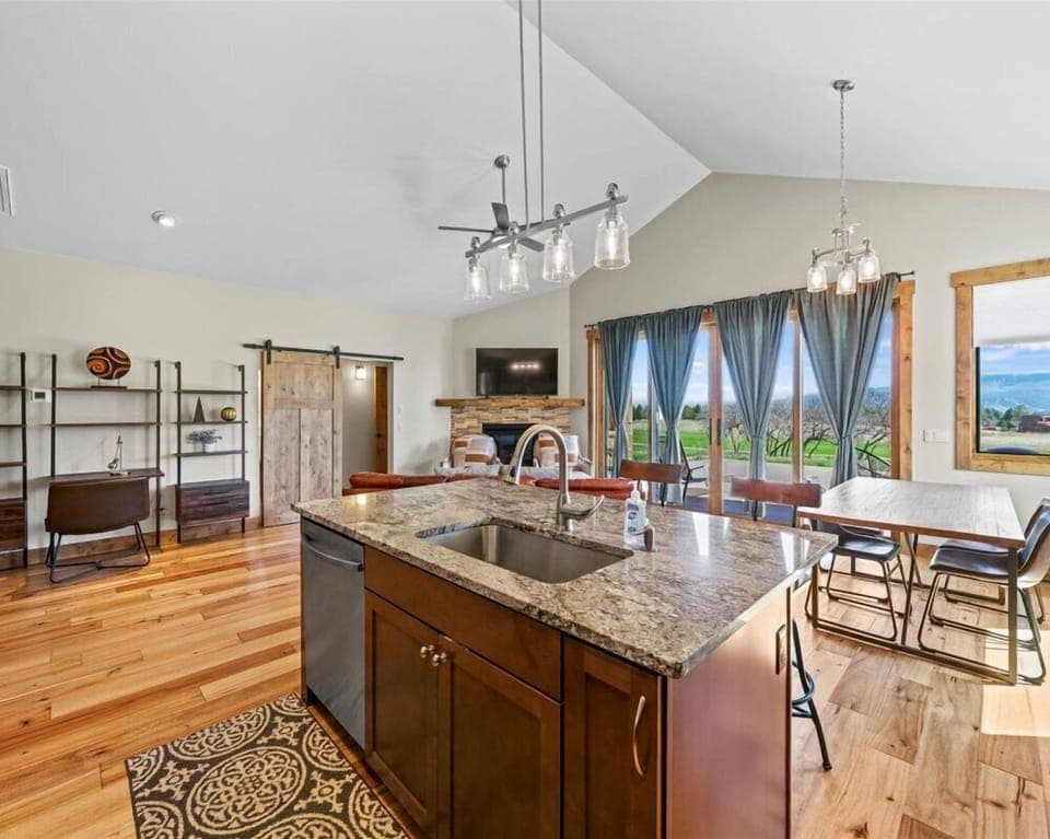 Open-concept living room with cozy seating and panoramic views.