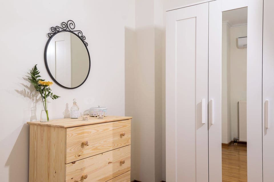 Guest room : A closet with hangers and a chest of drawers. The room is equipped with individuall A/C.