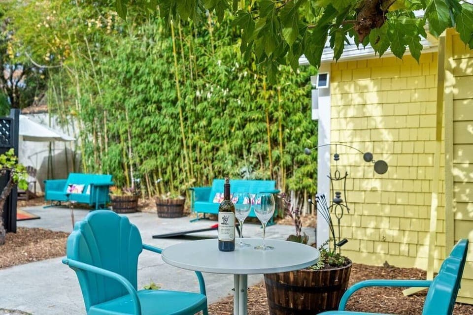 Private outdoor living with games, gliders, and shady Adirondack seating!