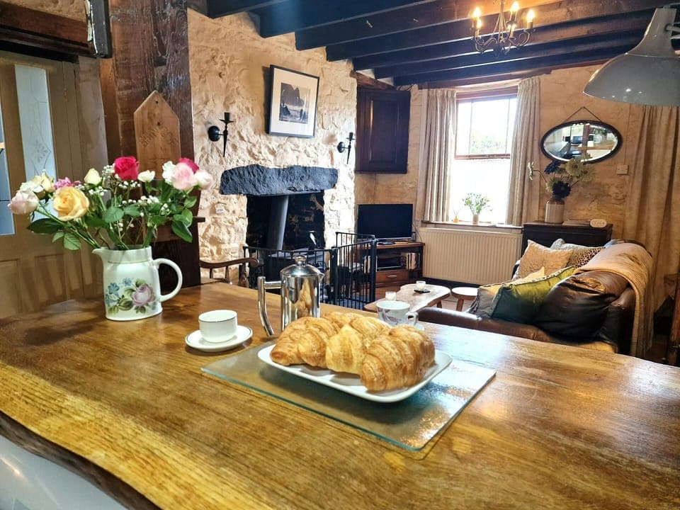 Kitchen worktop with coffee pot, coffee cups and plate of croissants