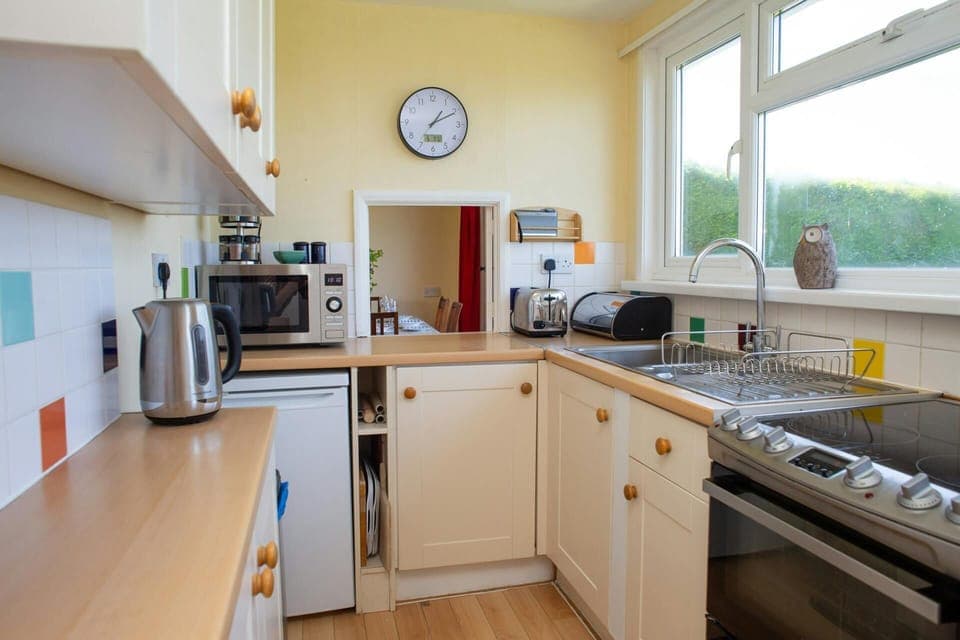 Kitchen with electric cooker, microwave, kettle, toaster and fridge