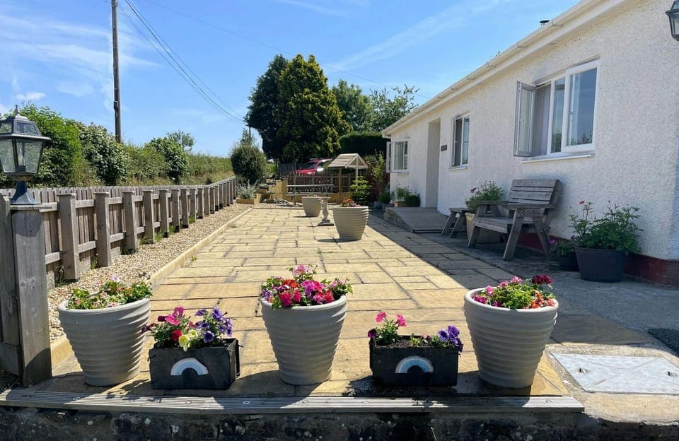 exterior patio with plant pots around the edges