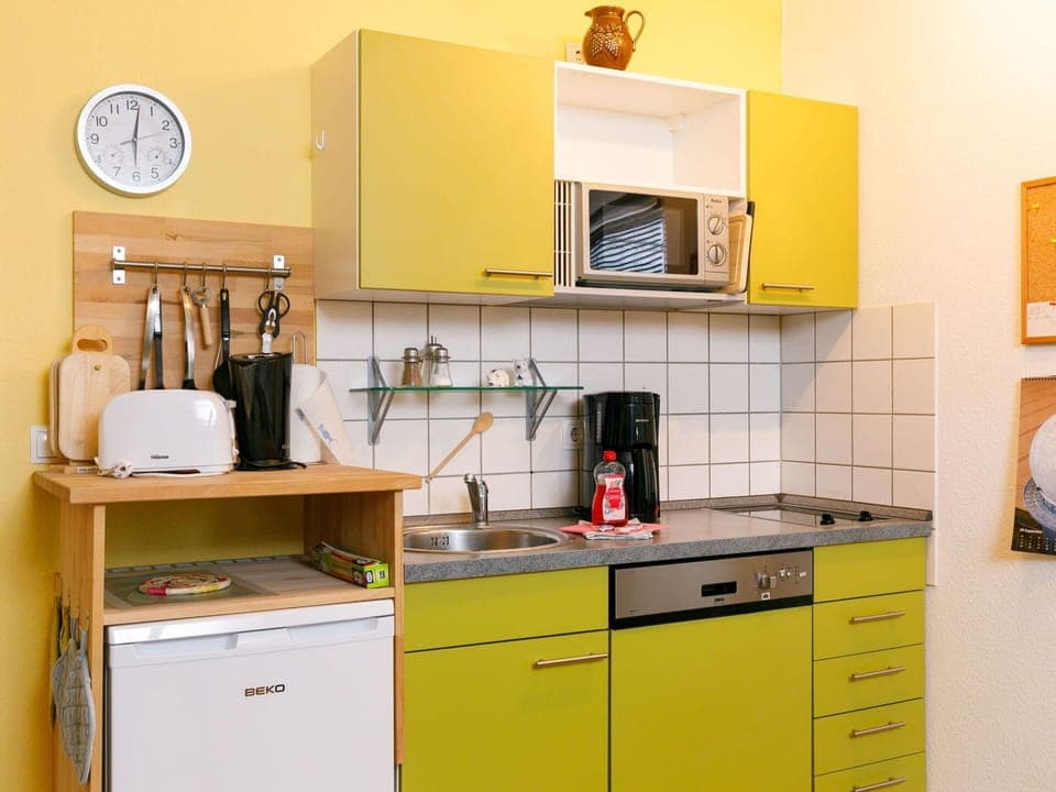 Cabinetry, Property, Countertop, Drawer, Interior Design, Lighting, Kitchen, Yellow, Kitchen Appliance, Clock