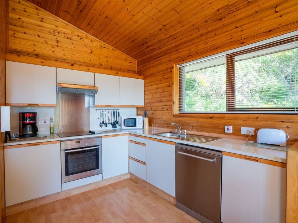 Cabinetry, Countertop, Property, Sink, Kitchen Appliance, Kitchen Stove, Kitchen Sink, Kitchen, Window, Wood