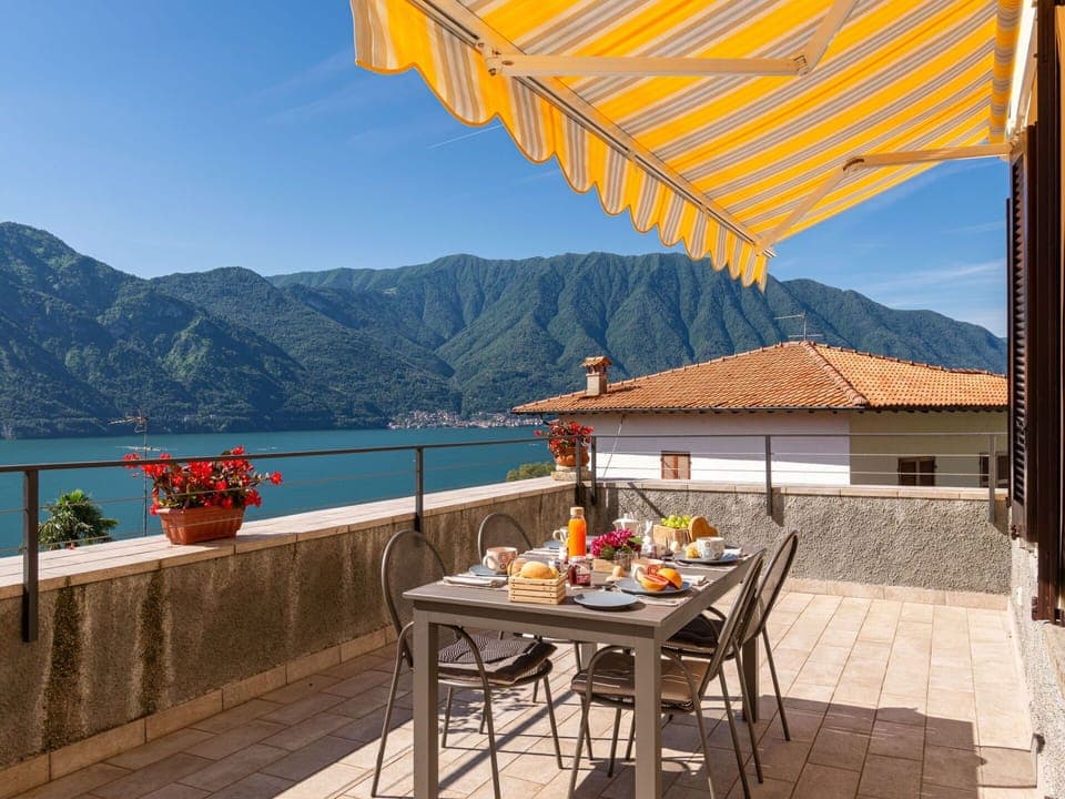 Table, Sky, Property, Mountain, Furniture, Building, Flowerpot, Water, Azure, Outdoor Furniture