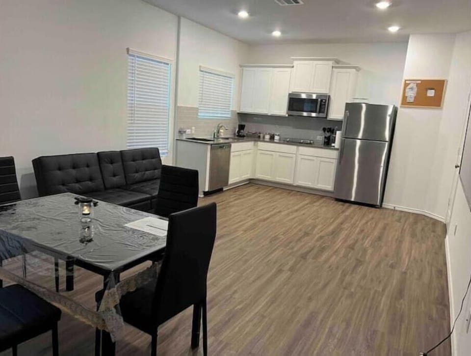 Spacious dining area, comfortable living room with a plush sofa and 75-inch TV.