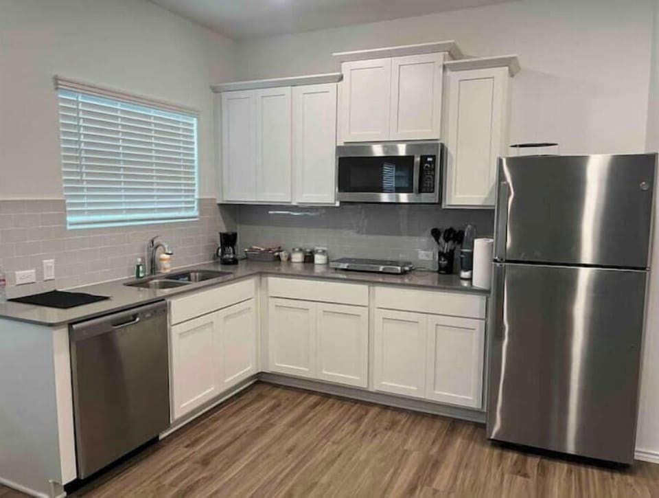 Full Kitchen: Refrigerator, Microwave cum oven, dishwasher, 2-burner induction