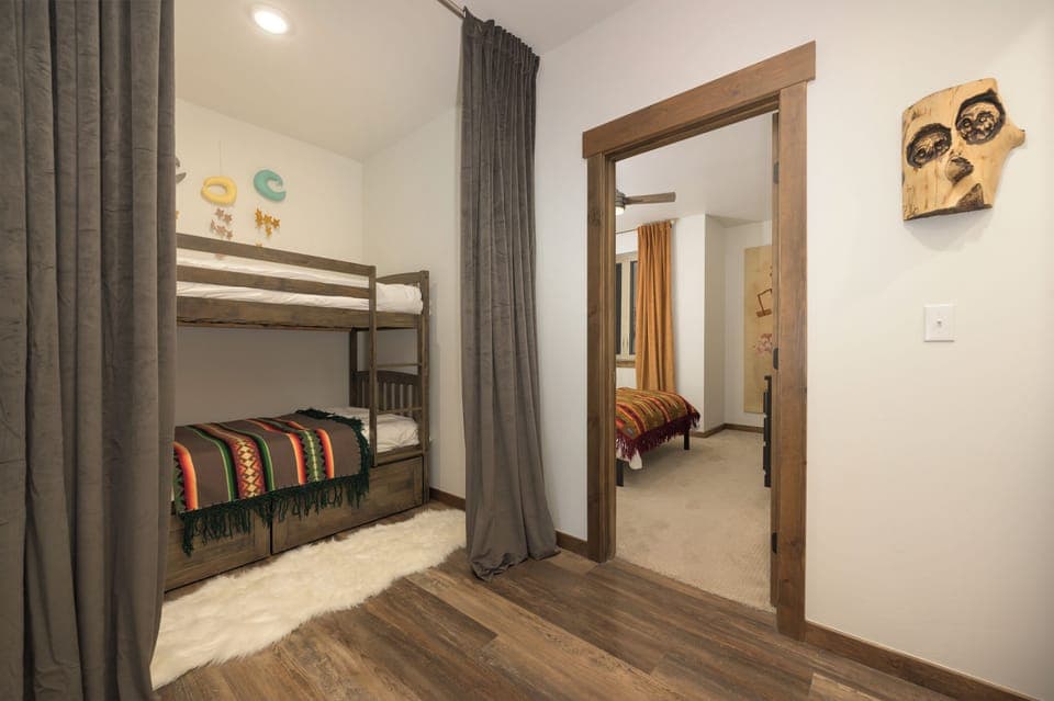 Your kids will love these cozy bunk beds, perfect for fun sleepovers and adventurous nights in this thoughtfully designed bedroom.