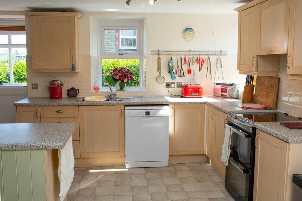 Wall and base cupboards. Dishwasher. Door to rear garden