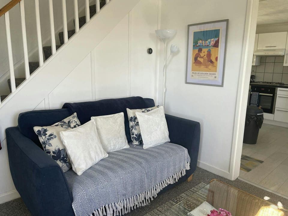 Sitting room with sofa and stairs leading to the first floor