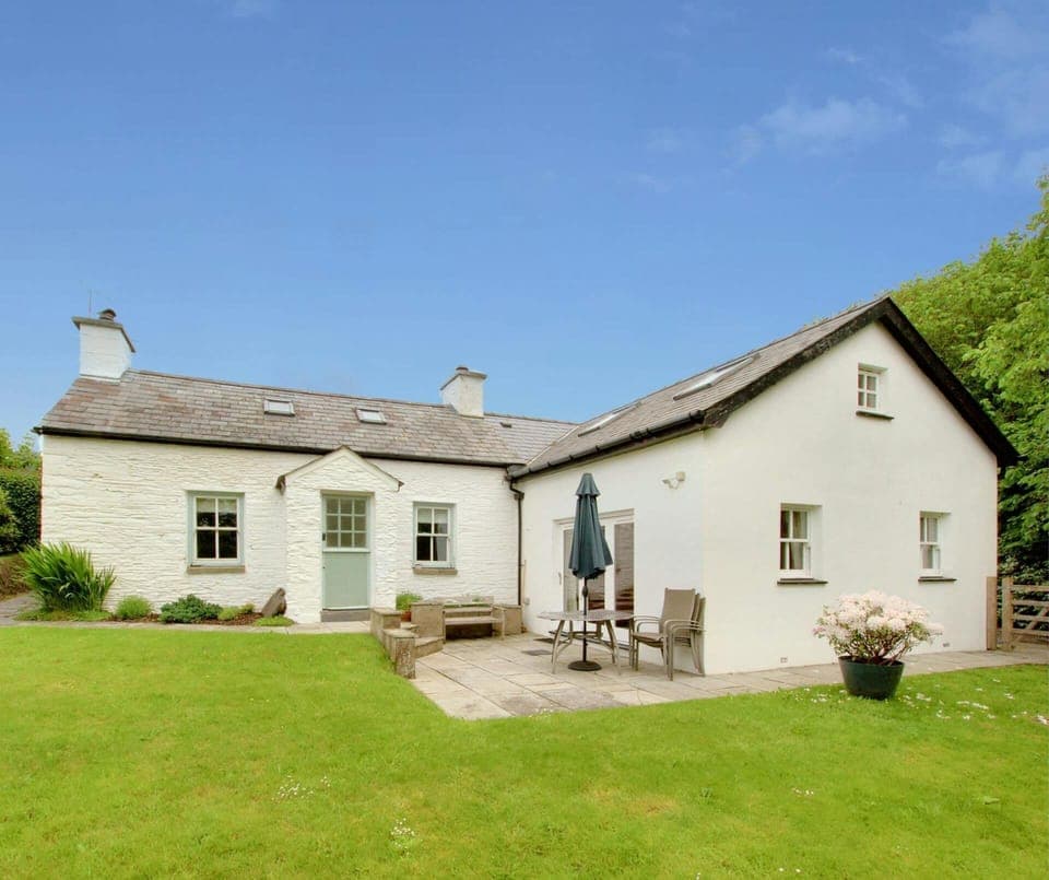 Brynllin with patio area with table and chairs and lawn