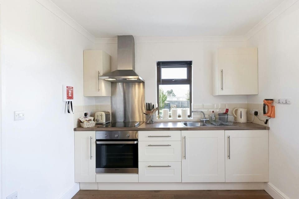 Kitchen; oven and hob, extractor fan, sink, cabinets, kettle, toaster and worktop