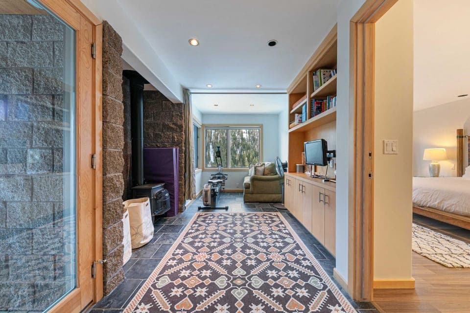 A charming nook space on the lower level offers a nice space to read, exercise, or take in the views. From here you can access the lower level deck with a hot tub.