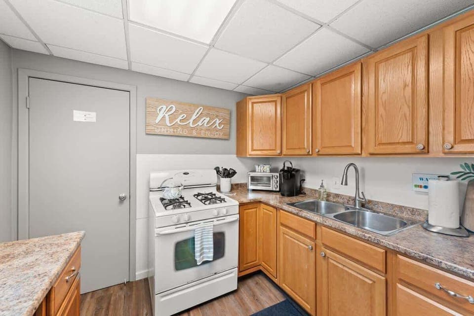 - Fully equipped kitchen with gas stove and appliances   - Ample counter space for preparing home cooked meals   - Relax sign and warm design create a cozy cooking space