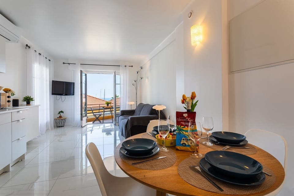 You'll love the dining room with its four-seat wooden table, the fully equipped kitchen with its white cabinets, and the lovely living room with its balcony.