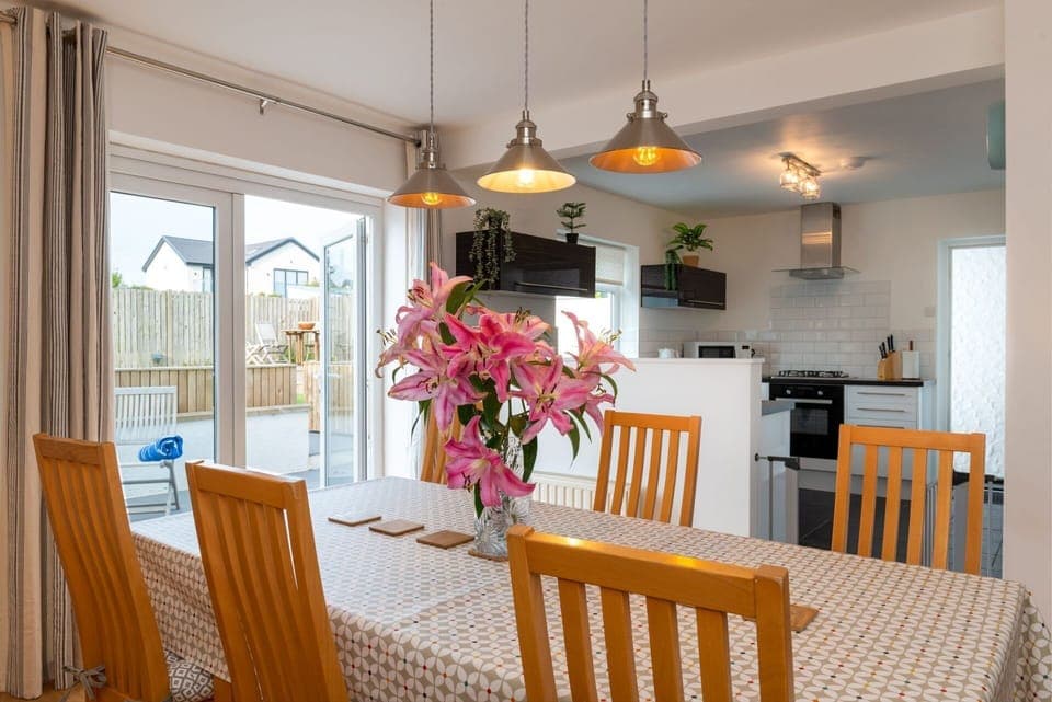 Cae Cloc dining table with kitchen in background