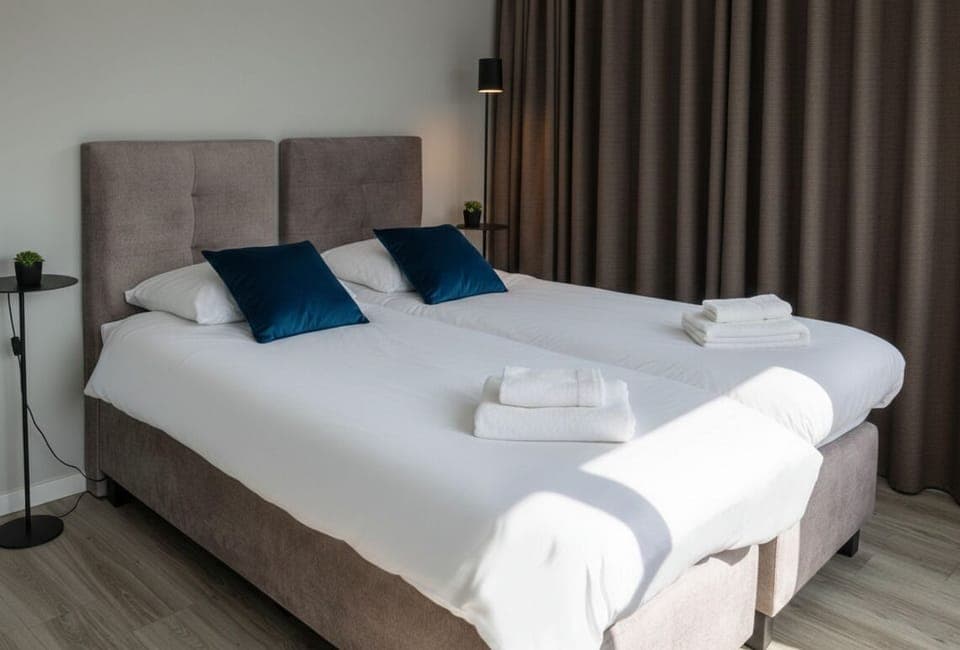 Bright bedroom with cozy linens and blackout curtains — your peaceful base in Raamsdonksveer, Noord-Brabant.