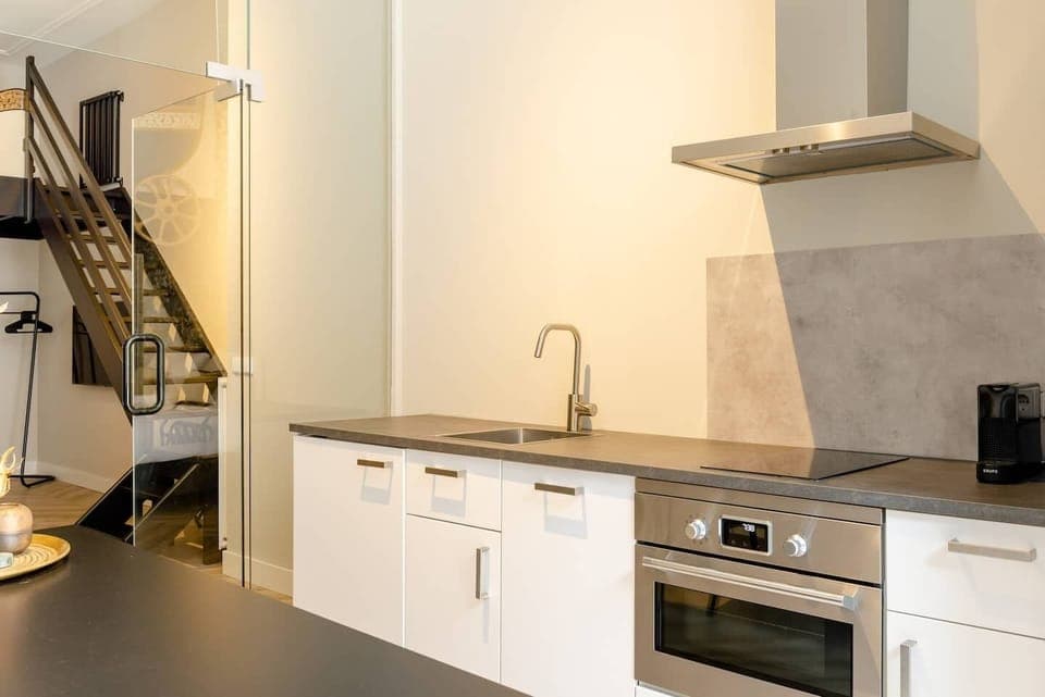 A contemporary kitchen with clean lines, equipped with essential appliances, offering a functional and efficient space.