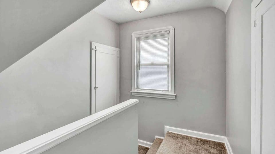 Stairway leading to the bedrooms—elegant steps that guide you to a restful retreat. A simple transition from the main living areas to where comfort and relaxation await at the top.