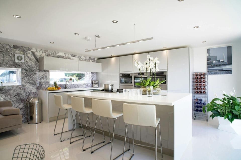 Oven, combination microwave, counter seating for 4, 3-seater sofa and wine rack