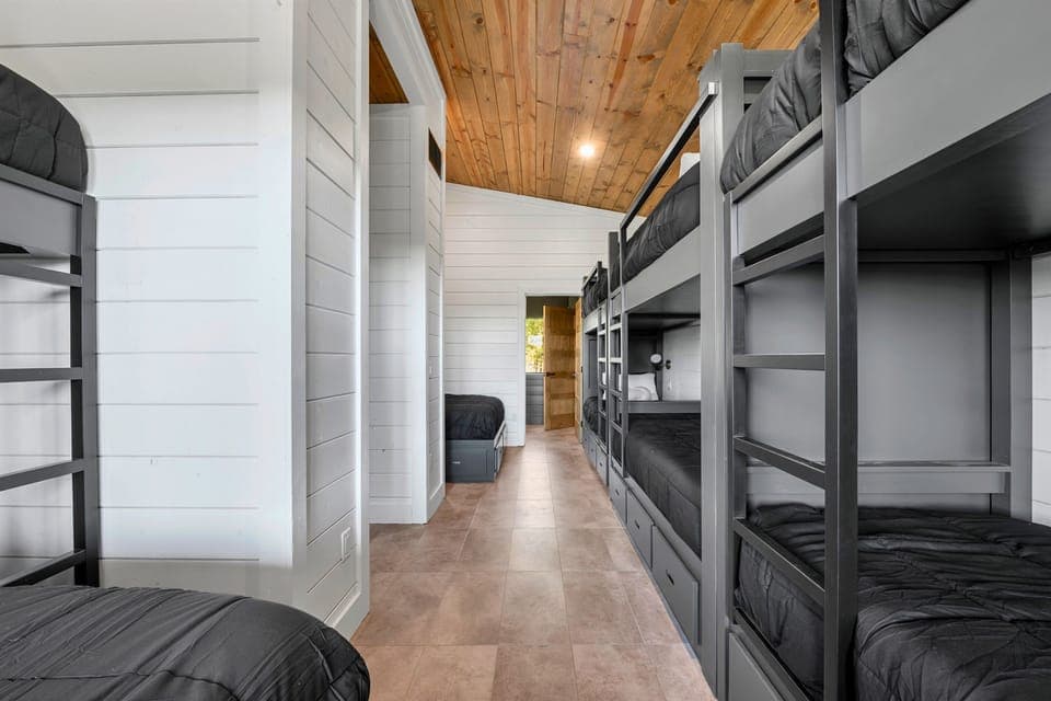 Every nook of this vacation home spells comfort, right down to this stylish bunk corridor with plush beds to crash in after a long day.
