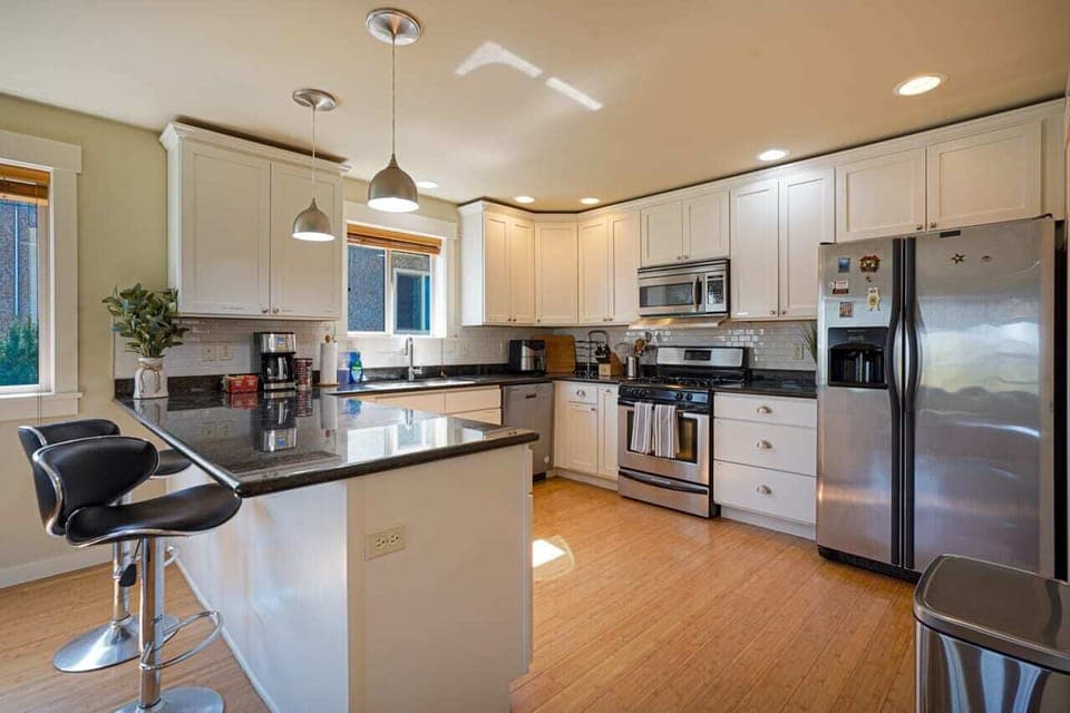 Indulge your culinary passions in the spacious, fully-equipped chef's kitchen, featuring a breakfast bar for two